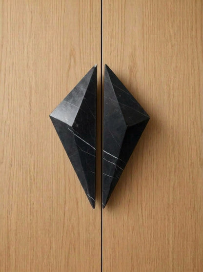 Yukixstone Diamond Stone Pull pair in Nero Marquina installed on closed oak double doors - the two faceted halves meet to form a full diamond