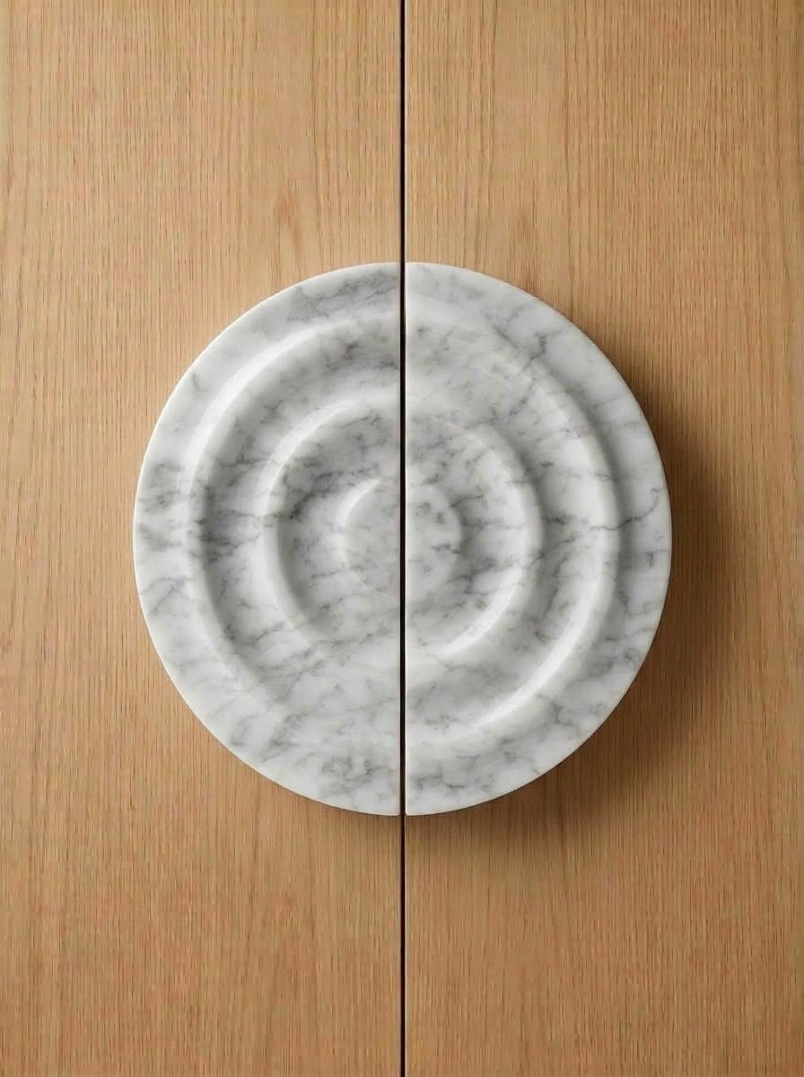 Yukixstone Bianco Carrara natural stone disc pull pair - hand-carved round marble door pull with concentric ripple carving, split across a pair of doors
