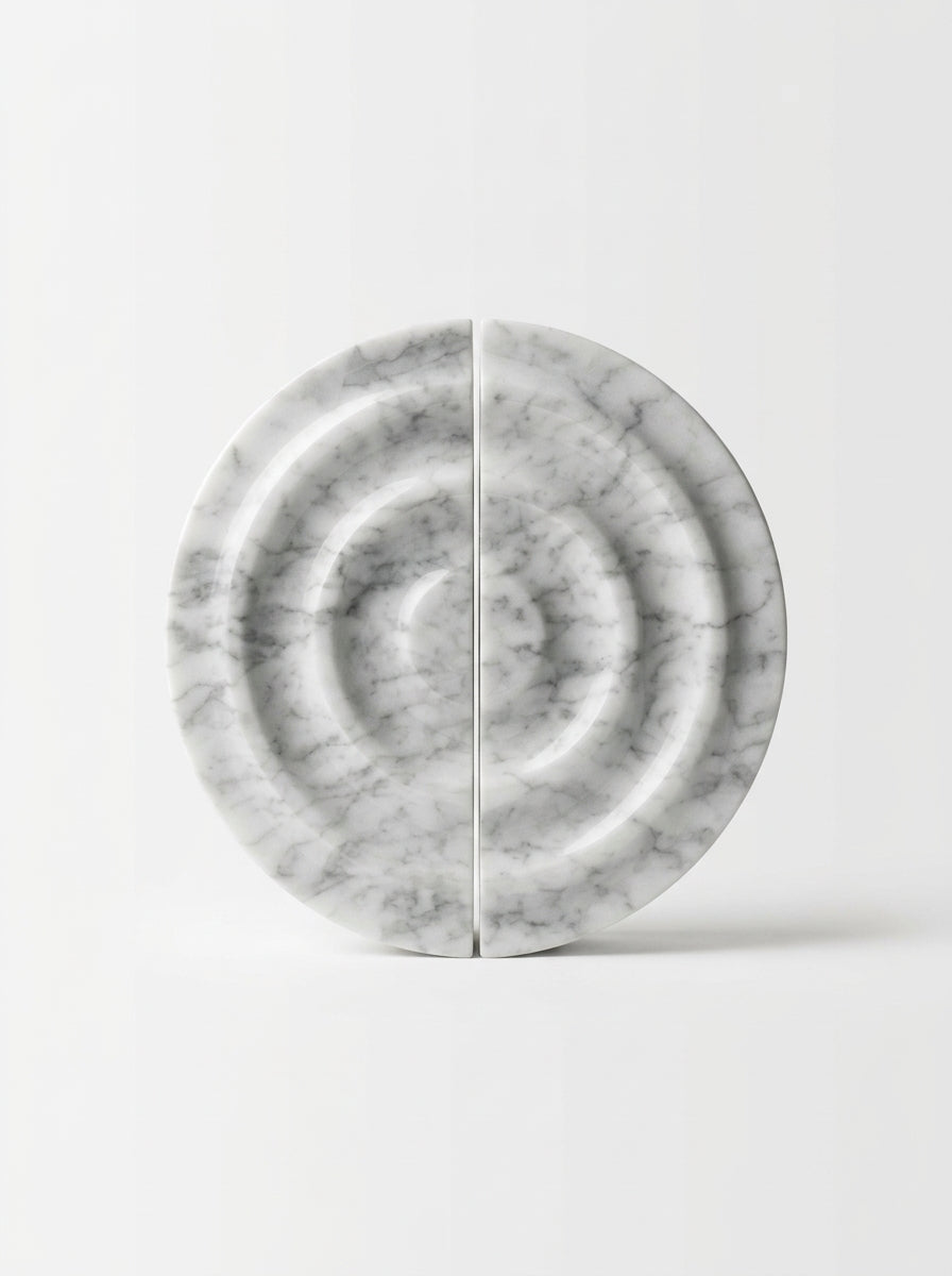 Yukixstone disc stone pull detail - carved marble disc with concentric ripple rings mounted on a wall