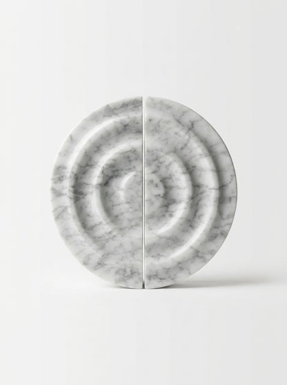 Yukixstone disc stone pull detail - carved marble disc with concentric ripple rings mounted on a wall