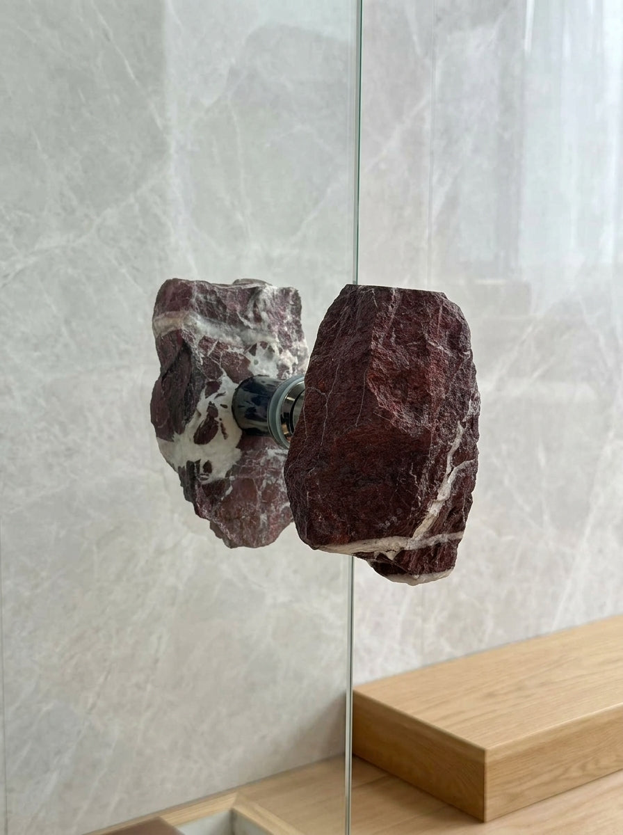 Brecciated jasper stone pull set on a glass door opening to a courtyard garden