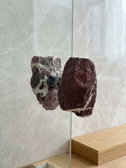 Brecciated jasper stone pull set on a glass door opening to a courtyard garden