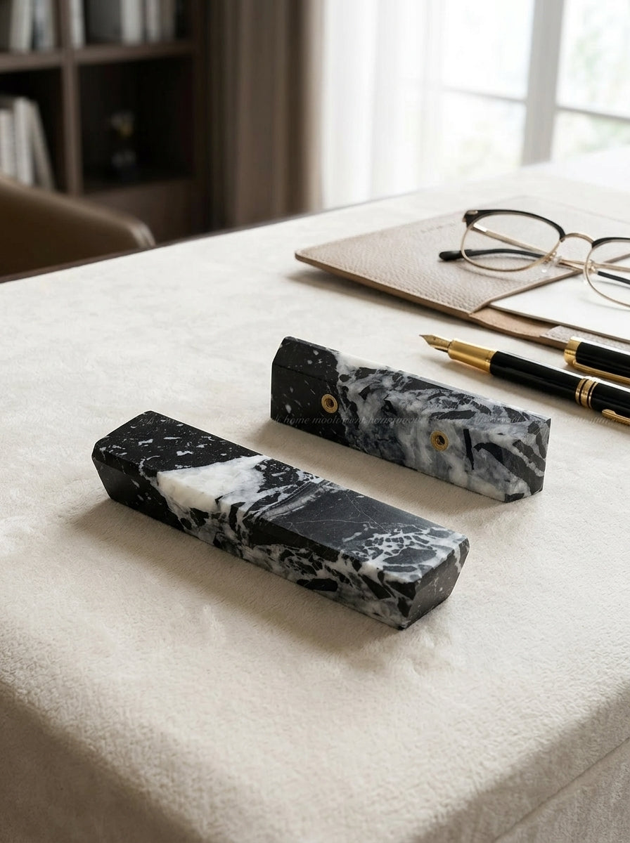 Yukixstone Ingot Stone Door Pull - two single-side Nero Marquina marble ingots styled on a plush towel with a fountain pen and reading glasses