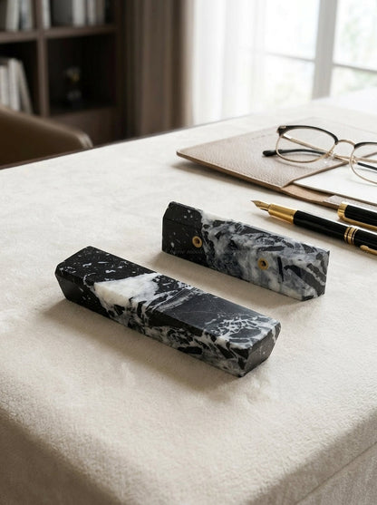Yukixstone Ingot Stone Door Pull - two single-side Nero Marquina marble ingots styled on a plush towel with a fountain pen and reading glasses