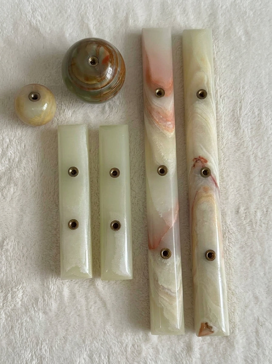 Yukixstone Onyx Bar Stone Pull - full onyx hardware family on white plush fabric: small and large ball knobs plus short and long bar pulls, each with concealed brass threaded inserts