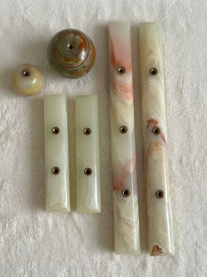 Yukixstone Onyx Bar Stone Pull - full onyx hardware family on white plush fabric: small and large ball knobs plus short and long bar pulls, each with concealed brass threaded inserts