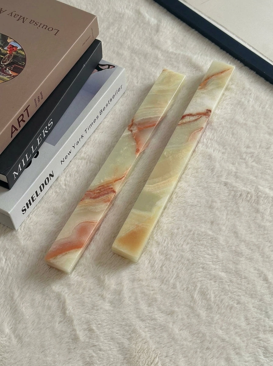 Yukixstone Onyx Bar Stone Pull - long size pair shown beside hardcover books for scale, showing the slim square section and chamfered edges