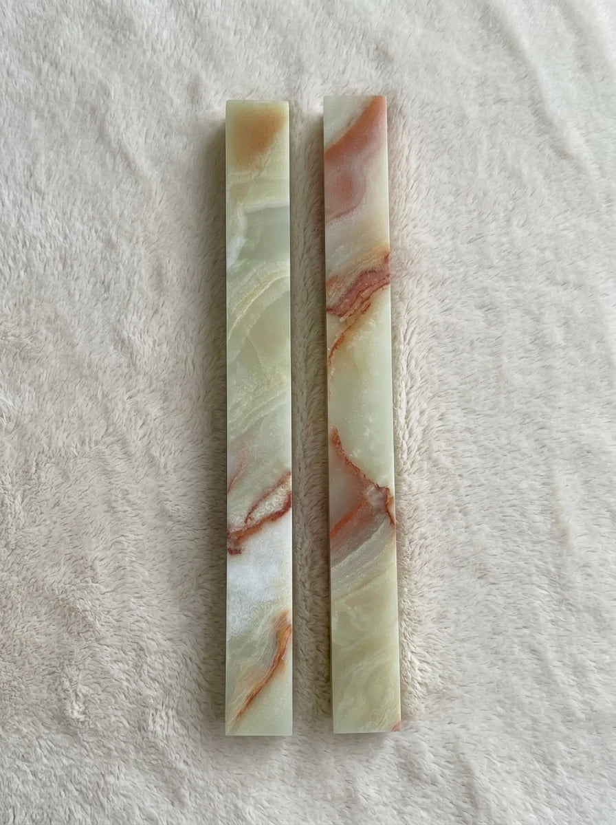Yukixstone Onyx Bar Stone Pull - long size pair of hand-polished green onyx bar pulls with translucent jade-green body and coral-amber veining, laid on white plush fabric
