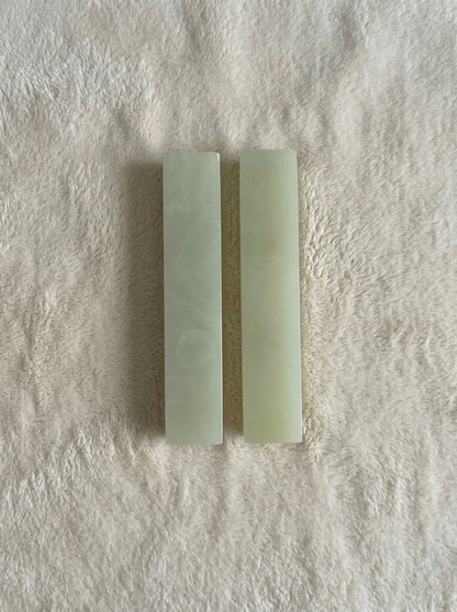 Yukixstone Onyx Bar Stone Pull - short size pair shown from the reverse with plain pale-green polished faces, laid on white plush fabric