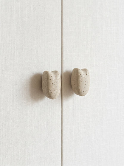 Yukixstone Classic Travertine stone pebble knobs installed on wardrobe doors - cream travertine cabinet knob pair
