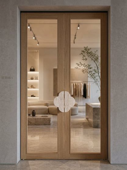 Yukixstone quatrefoil stone pulls installed on boutique double doors - travertine clover door hardware
