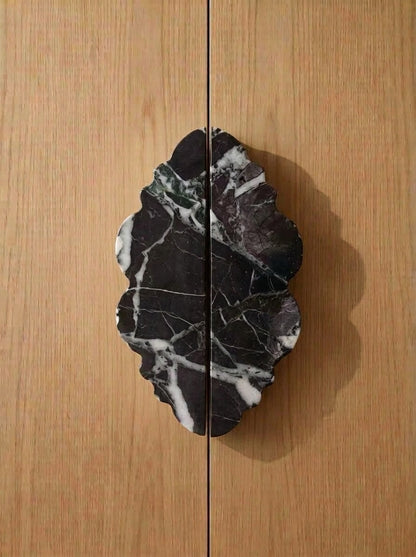 Yukixstone Ridge Stone Door Pull - lobed split pull hand-carved in Nero Marquina black marble with white veining, mounted on oak double doors