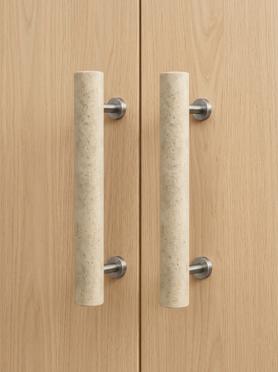 Beige travertine cylinder stone door pull pair mounted on light oak double doors