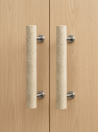 Beige travertine cylinder stone door pull pair mounted on light oak double doors
